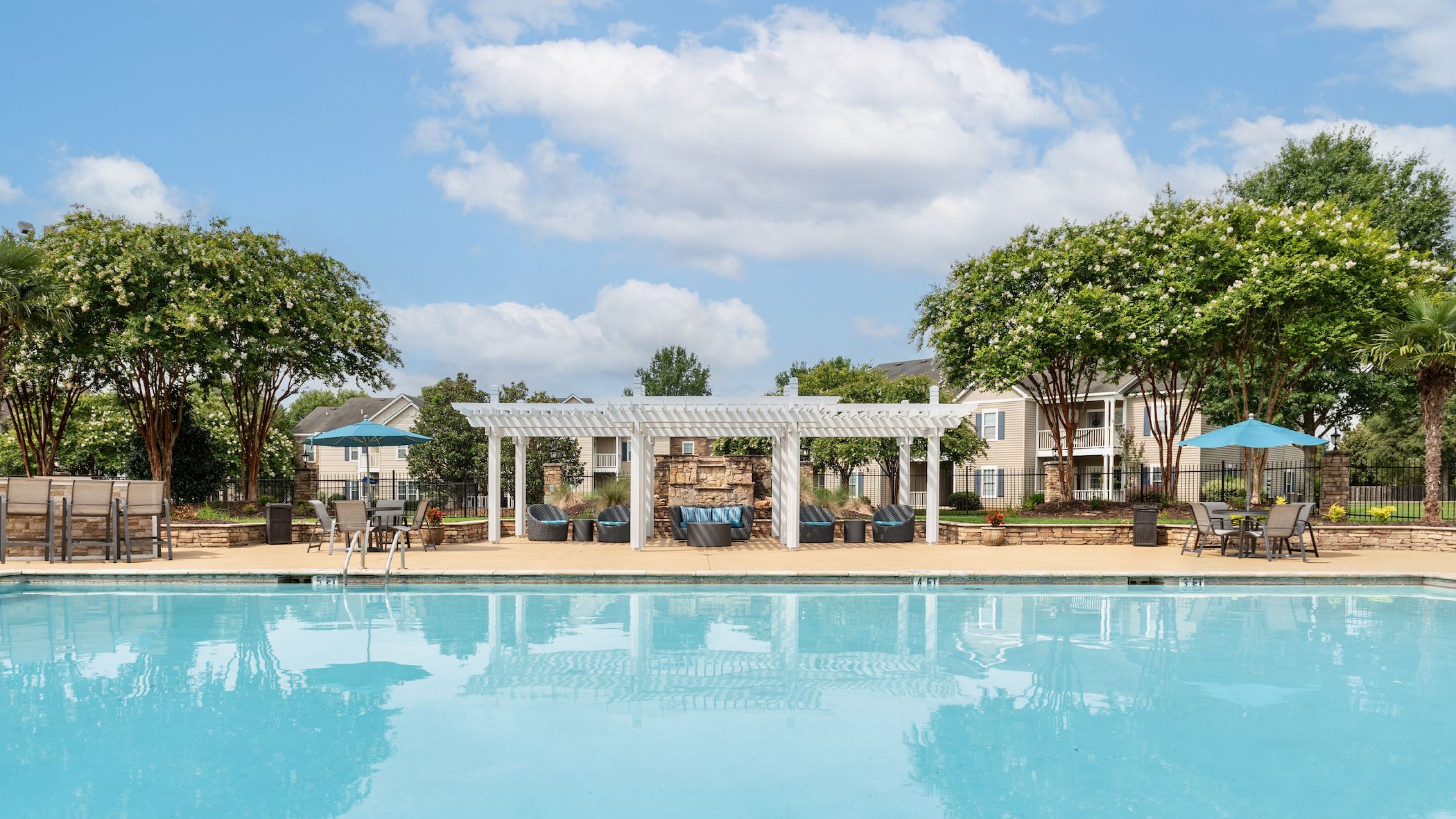 Tranquil poolside retreat with pergolas at Hawthorne Meadowview apartments in Warner Robins