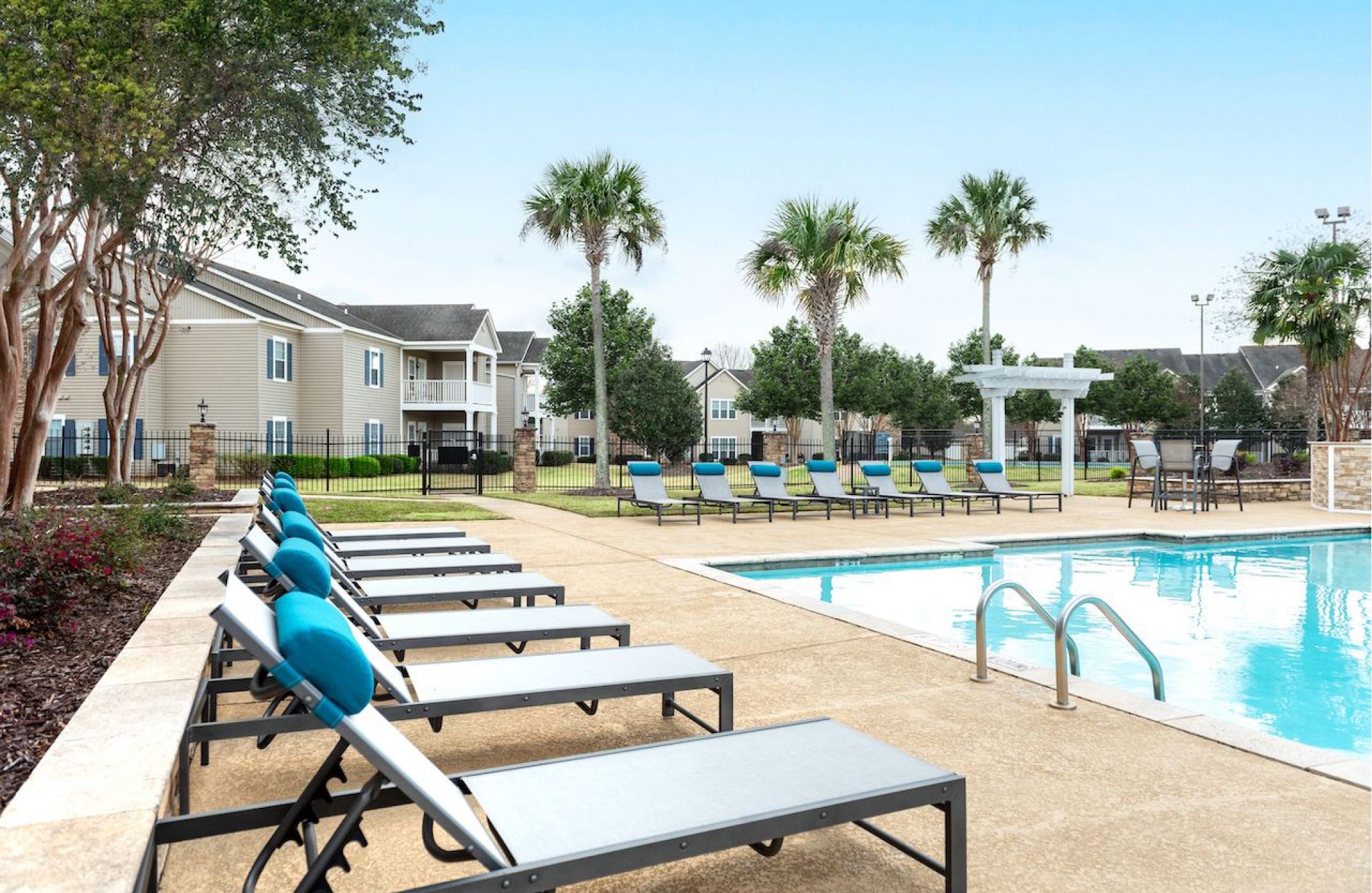 Sunlit pool lounge with comfortable seating at Hawthorne Meadowview in Warner Robins, Georgia